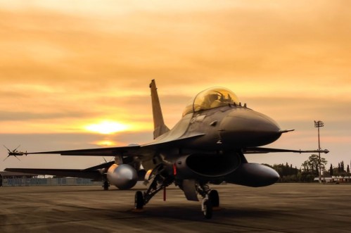 Picture of F16 falcon fighter jet on sunset  background 