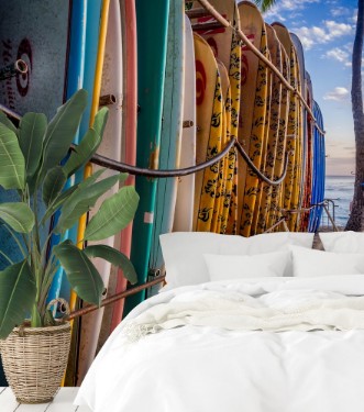 Colourful surfboards stacked up on Waikiki Beach at sunset photowallpaper Scandiwall